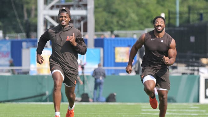 Browns QB Deshaun Watson and pass rusher Myles Garrett warm up before the Hall of Fame game vs. the New York Jets at Tom Benson Hall of Fame Stadium.