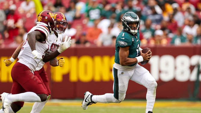 Philadelphia Eagles QB Jalen Hurts evading the Washington Commanders defense at FedExField in Landover, Maryland.