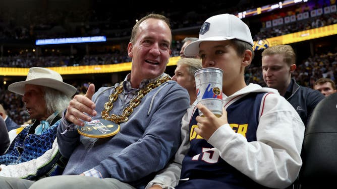 Peyton Manning enjoys the Denver Nuggets NBA Finals with his son