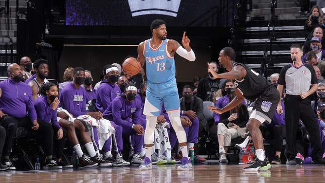 Los Angeles Clippers SF Paul George handles the ball against Sacramento Kings SF Harrison Barnes at Golden 1 Center in Sacramento, California.
