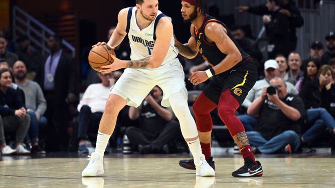 Dallas Mavericks All-Star Luka Doncic posts up on Cleveland Cavaliers wing Lamar Stevens at Rocket Mortgage Fieldhouse in Cleveland, Ohio.