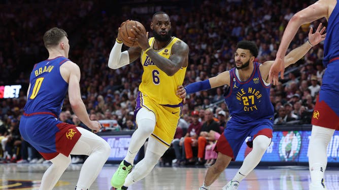 Lakers' LeBron James drives to the basket between Nuggets F Christian Braun and PG Jamal Murray during Game 1 of the WCF at Ball Arena in Denver, Colorado.
