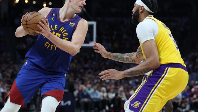 Jokic looks to pass the ball against Davis during the 3rd quarter in Game 1 of the WCF.
