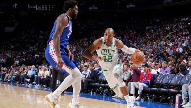 Celtics C Al Horford dribbles past 76ers big Joel Embiid 2023 at the Wells Fargo Center in Philadelphia.