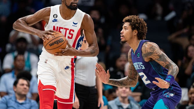 Charlotte Hornets SF Kelly Oubre Jr. defends Kevin Durant during their game at Spectrum Center in Charlotte, North Carolina.