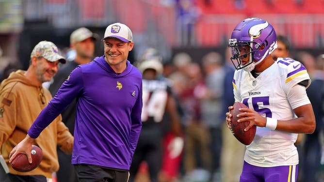 Minnesota Vikings coach Kevin O'Connell talks with QB Joshua Dobbs before the game vs. the Falcons at Mercedes-Benz Stadium in Atlanta, Georgia.