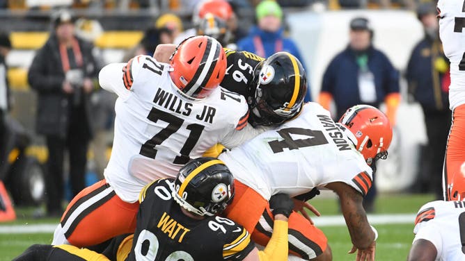 Cleveland Browns QB Deshaun Watson is sacked by Pittsburgh Steelers pass rushers T.J. Watt and Alex Highsmith at Acrisure Stadium.