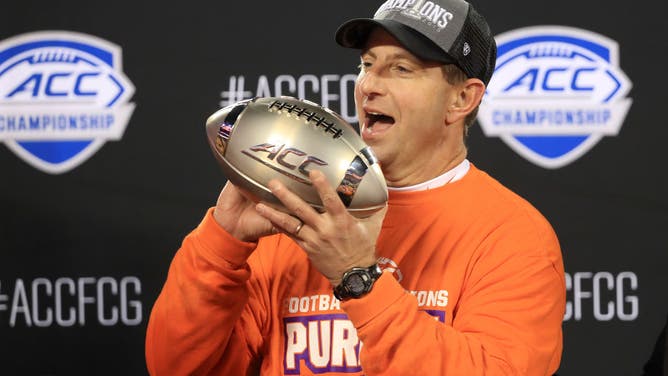 Clemson Tigers head coach Dabo Swinney celebrates with the trophy after defeating the Virginia Cavaliers 64-17 in the 2019 ACC Football Championship game at Bank of America Stadium in Charlotte, North Carolina.