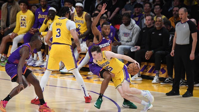Lakers' guard Austin Reaves takes a pick from Anthony Davis vs. the Suns at Crypto.Com Arena in Los Angeles.
