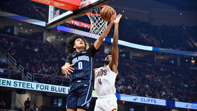 Orlando Magic guard Anthony Black attempts a layup past Cavaliers big Evan Mobley at Rocket Mortgage Fieldhouse in Cleveland, Ohio.