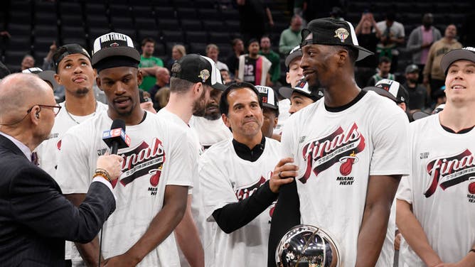 Heat SF Jimmy Butler is awarded the Larry Bird Trophy as Adebayo holds the Bob Cousy Trophy after Miami won the Eastern Conference Finals at the TD Garden in Boston.