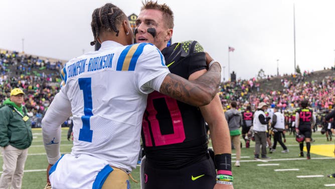 Quarterback Bo Nix of the Oregon Ducks shakes hands with Quarterback Dorian Thompson-Robinson of the UCLA Bruins