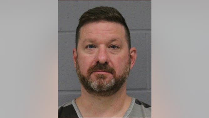 Booking photo of Texas basketball coach Chris Beard.