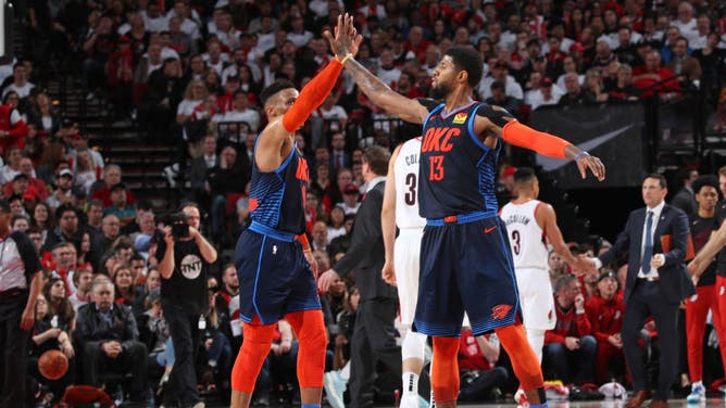 Russell Westbrook high-fives Paul George during the 2019 NBA Playoffs at the Moda Center in Portland, Oregon.