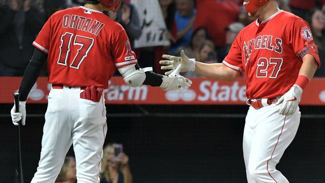 Shohei Ohtani congratulates Mike Trout on his home run vs. Mariners' Yusei Kikuchi at Angel Stadium in Anaheim, California.