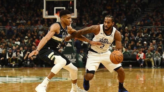 Clippers wing Kawhi Leonard drives around Bucks' All-Star Giannis Antetokounmpo at Fiserv Forumin Milwaukee, Wisconsin.