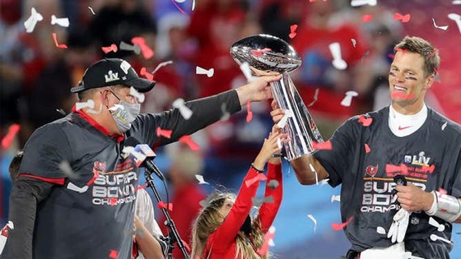 Super Bowl MVP Tom Brady of the Buccaneers accepts the Lombardi Trophy from general manager Jason Licht after Super Bowl LV between the Kansas City Chiefs and the Tampa Bay Buccaneers Feb. 7, 2021, at Raymond James Stadium, in Tampa, Fla.