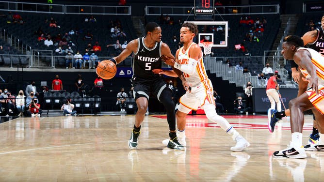 Sacramento Kings PG De'Aaron Fox goes against Atlanta Hawks PG Trae Young at State Farm Arena in Atlanta.