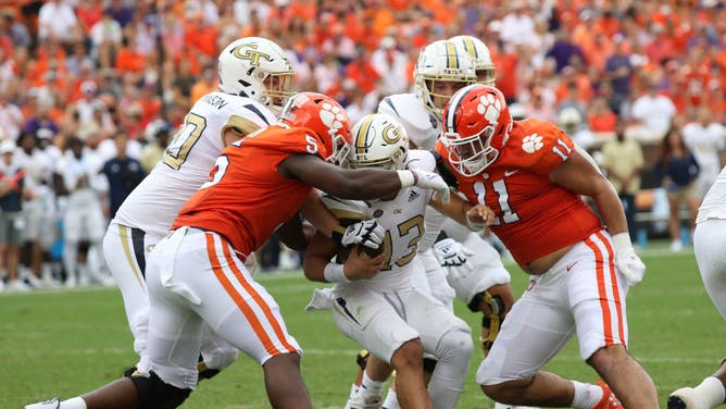 Clemson Tigers defensive linemen K.J. Henry and Bryan Bresee come together to sack Georgia Tech Yellow Jackets QB Jordan Yates at Clemson Memorial Stadium in Clemson, South Carolina.