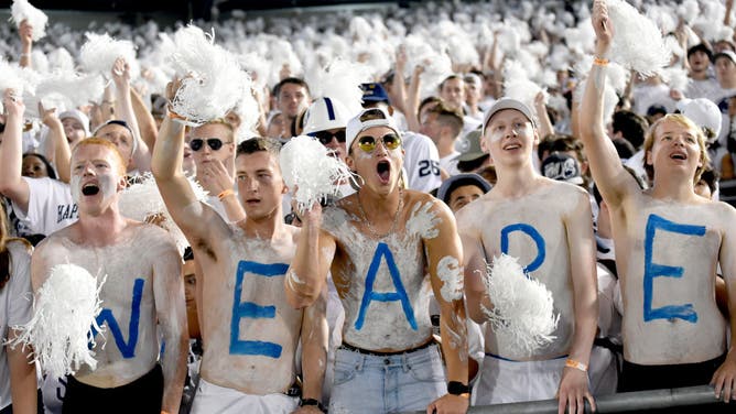 Penn State students and fans painted with body paint spelling