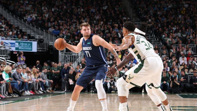 Dallas Mavericks PG Luka Doncic tries to pass the ball through the Milwaukee Bucks' defense at the Fiserv Forum Center in Milwaukee, Wisconsin.