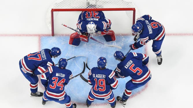 Team USA huddled around the net before a game.