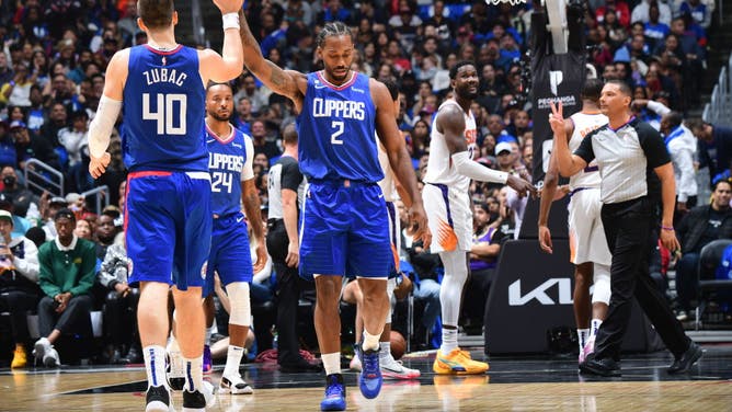 Los Angeles Clippers SF Kawhi Leonard high-fives teammate Ivica Zubac during the game against the Phoenix Suns on October 23, 2022 at Crypto.Com Arena in Los Angeles.