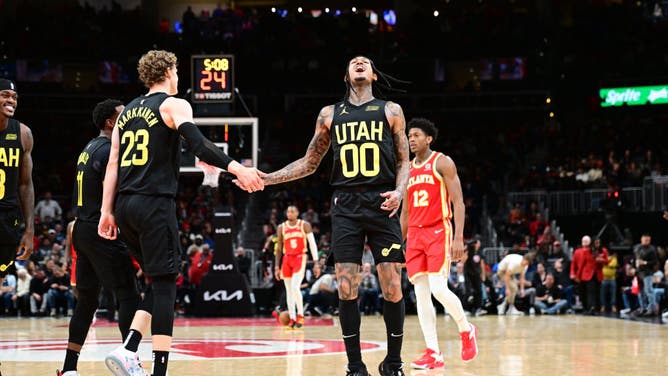 Jazz SG Jordan Clarkson celebrates with big Lauri Markkanen vs. the Hawks at State Farm Arena in Atlanta.