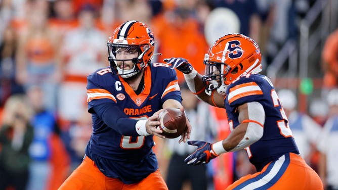 Syracuse Orange Garrett Shrader hands the ball to RB Sean Tucker against the Florida State Seminoles at JMA Wireless Dome in Syracuse, New York.