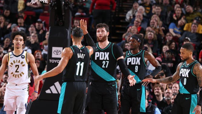 Portland Trail Blazers SF Josh Hart high-fives C Jusuf Nurkic during the game against the Indiana Pacers at the Moda Center Arena in Portland, Oregon.