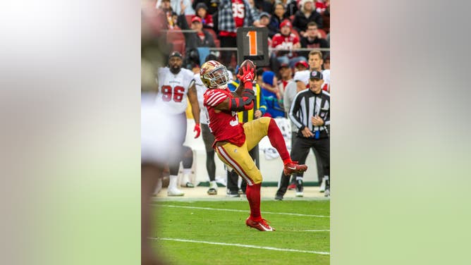 San Francisco 49ers linebacker Dre Greenlaw intercepts Tom Brady