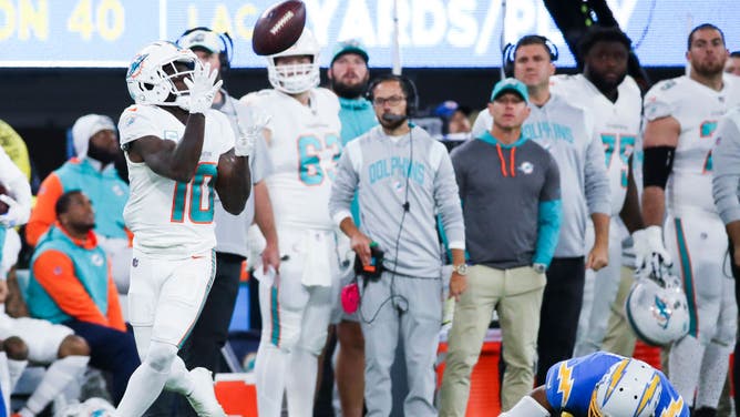 Even Dolphins quarterback Tua Tagovailoa can't miss Tyreek Hill when he makes a defender hit the grass.