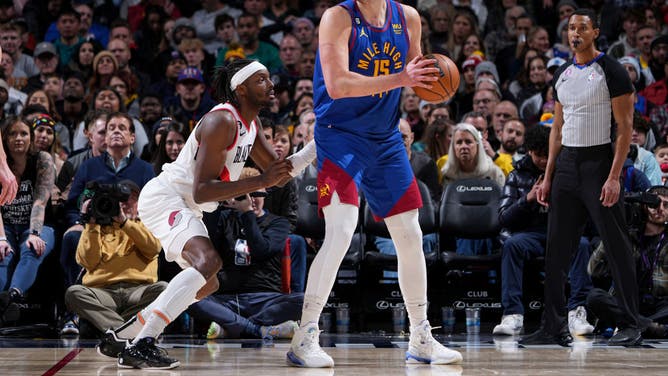 Denver Nuggets' Nikola Jokic posts up Portland Trail Blazers F Jerami Grant at the Ball Arena in Denver, Colorado.