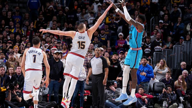 Suns' big Ayton shoots the ball over Nuggets big Jokic at the Ball Arena in Denver, Colorado.