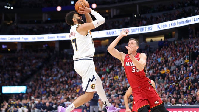 Denver Nuggets PG Jamal Murray shoots it over Miami Heat SG Duncan Robinson at Ball Arena in Denver, Colorado.