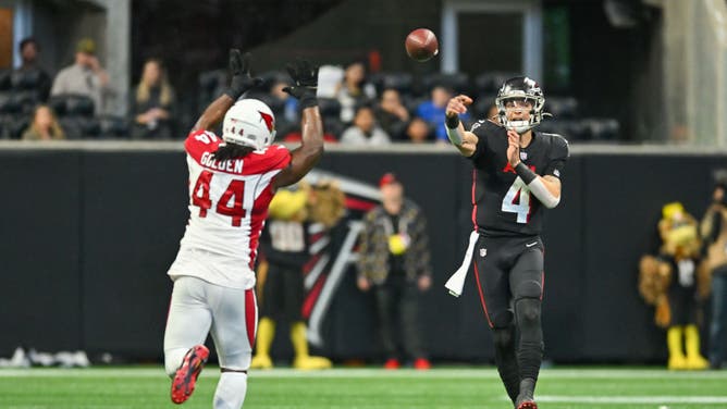 Atlanta Falcons QB Desmond Ridder throws a pass as Arizona Cardinals LB Markus Golden applies pressure at Mercedes-Benz Stadium in Atlanta.