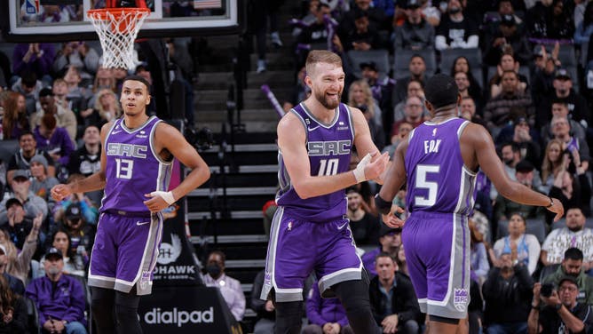 Sacramento Kings PF Domantas Sabonis celebrates with PG DeAaron Fox against the Utah Jazz at Golden 1 Center in Sacramento, California.