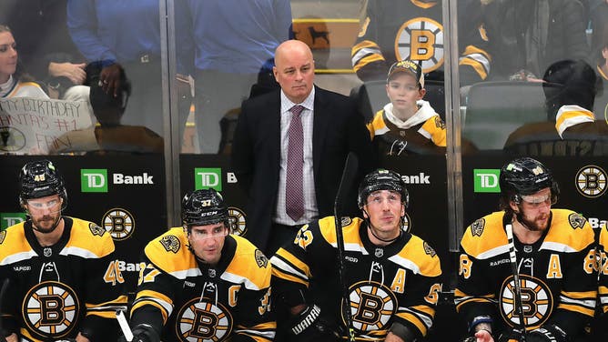 Jim Montgomery behind Bruins bench