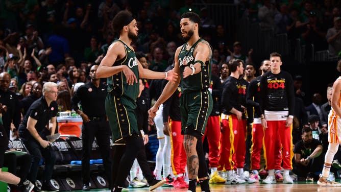 Celtics G Derrick White and SF Jayson Tatum high-five during Game 1 of the 2023 NBA Playoffs vs. the Hawks at the TD Garden in Boston.