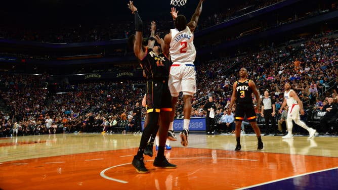 Kawhi Leonard dunks the ball on Deandre Ayton in Game 1 of the 2023 NBA Playoffs at Footprint Center in Phoenix.