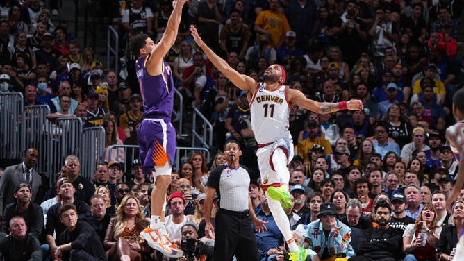 Nuggets SF Bruce Brown contests a Booker jump shot during Game 5 of the Western Conference Semifinals at the Ball Arena.