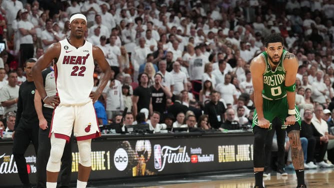 Jimmy Butler of the Miami Heat and Jayson Tatum of the Boston Celtics look on during Game Six of the Eastern Conference Finals.