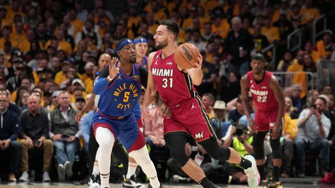 Heat SG Max Strus gets rid of the ball while Nuggets SG Kentavious Caldwell-Pope hounds him during Game 1 of the 2023 NBA Finals.