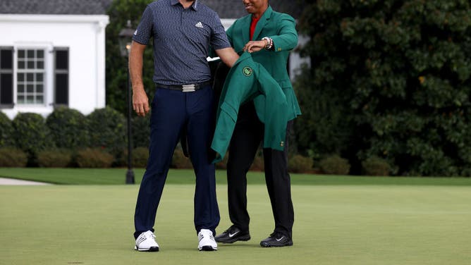 DJ is awarded the green jacket by 2019 Masters champion Tiger Woods after Johnson won the 2020 Masters.