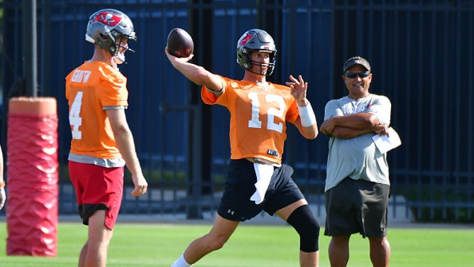 Clyde Christensen oversees Brady at practice.