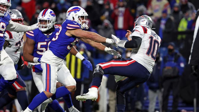 Buffalo Bills LB Matt Milano shoves New England Patriots QB Mac Jones after a pass during the third quarter in the AFC Wild Card playoff game at Highmark Stadium in Buffalo, New York.