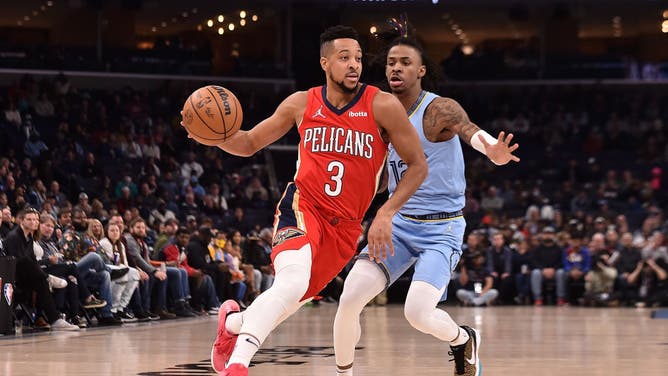 New Orleans Pelicans SG CJ McCollum drives by Memphis Grizzlies PG Ja Morant at FedExForum in Memphis, Tennessee.