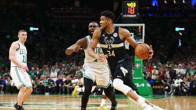 Milwaukee Bucks SF Giannis Antetokounmpo dribbles against Boston Celtics SF Jaylen Brown at TD Garden in Boston.