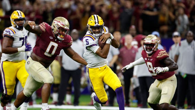 LSU QB Jayden Daniels is tackled by Florida State DT Fabien Lovett at Caesars Superdome.