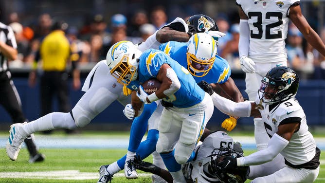 Chargers RB Austin Ekeler runs over Jaguars LB Devin Lloyd at SoFi Stadium in Inglewood, California.